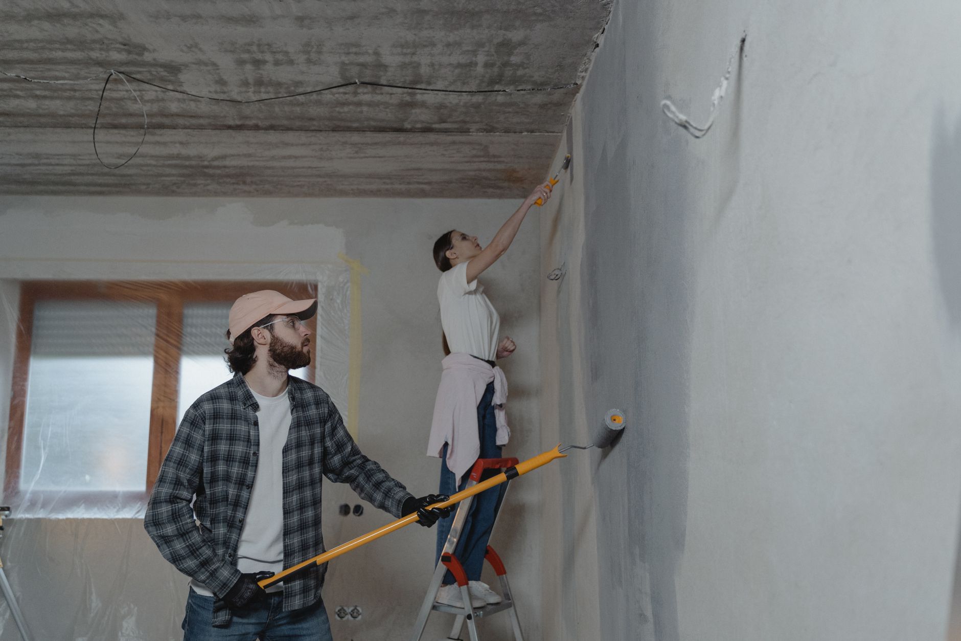 A couple painting a room together, highlighting teamwork in home renovation in Pasadena, CA